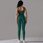 Woman wearing dark green sleeveless jumpsuit